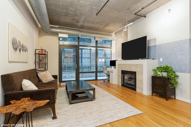 520 S State St Unit 614, Chicago, IL 60605 - living area with wood finished floors, expansive windows, a tiled fireplace, and track lighting