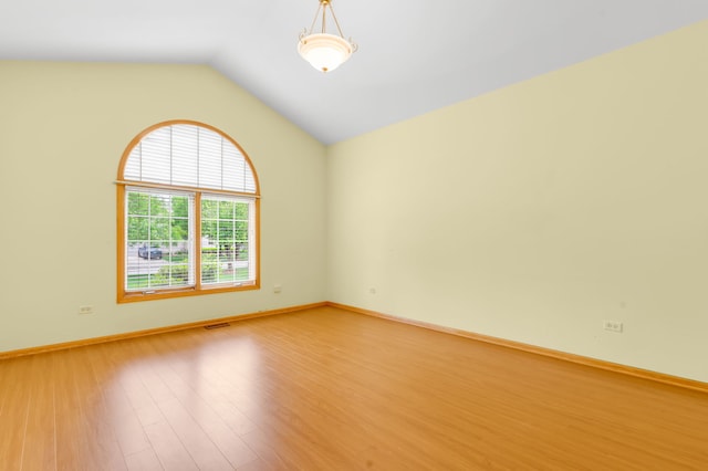11104 Karen Dr, Orland Park, IL 60467 - spare room featuring light wood-type flooring, vaulted ceiling, and baseboards