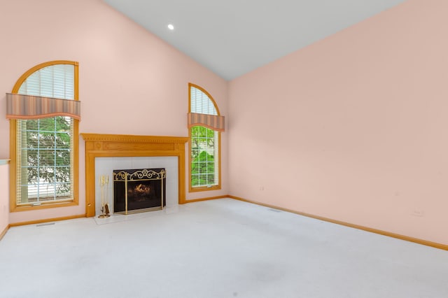 11104 Karen Dr, Orland Park, IL 60467 - unfurnished living room with carpet flooring, baseboards, a tiled fireplace, and high vaulted ceiling