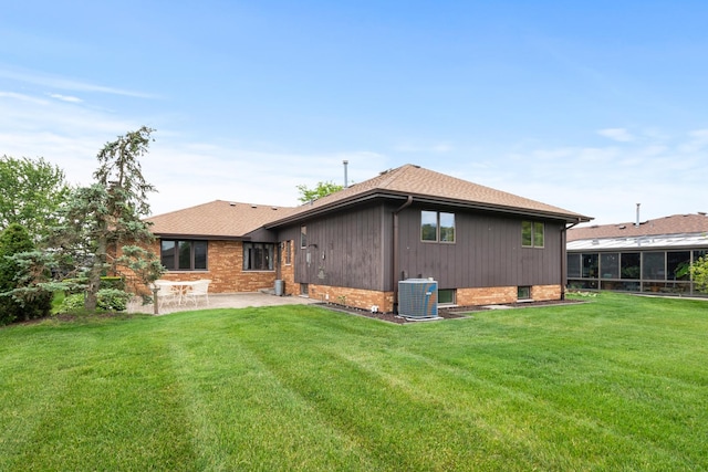 7618 W 157th St, Orland Park, IL 60462 - rear view of property with a patio area, cooling unit, a lawn, brick siding, and roof with shingles