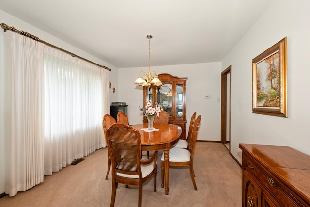 7618 W 157th St, Orland Park, IL 60462 - dining space with a chandelier, light colored carpet, and baseboards