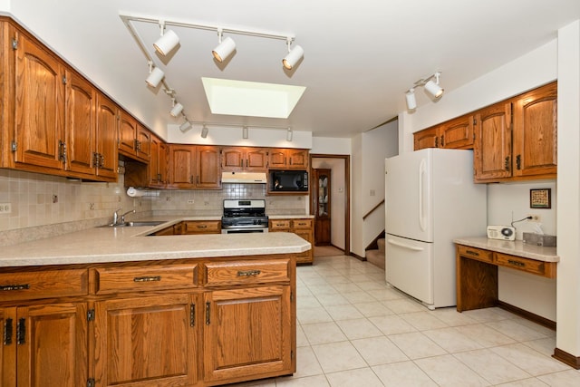 7618 W 157th St, Orland Park, IL 60462 - kitchen with freestanding refrigerator, black microwave, stainless steel range with gas cooktop, rail lighting, and a sink
