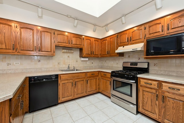 7618 W 157th St, Orland Park, IL 60462 - kitchen with black appliances, under cabinet range hood, a sink, brown cabinets, and rail lighting