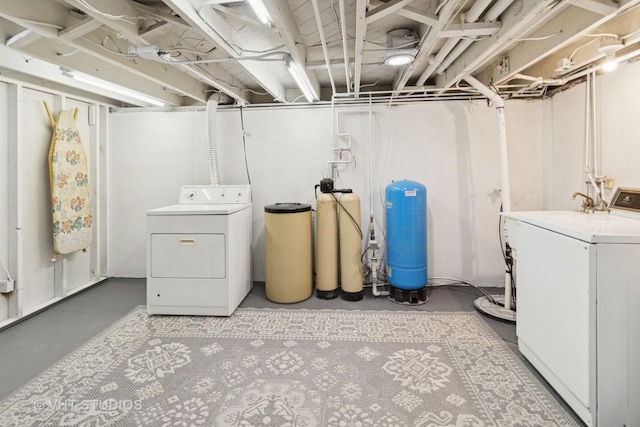 2309 N Riverside Dr, Mchenry, IL 60051 - unfinished below grade area with washing machine and clothes dryer, a water pressure tank, and a water softener system