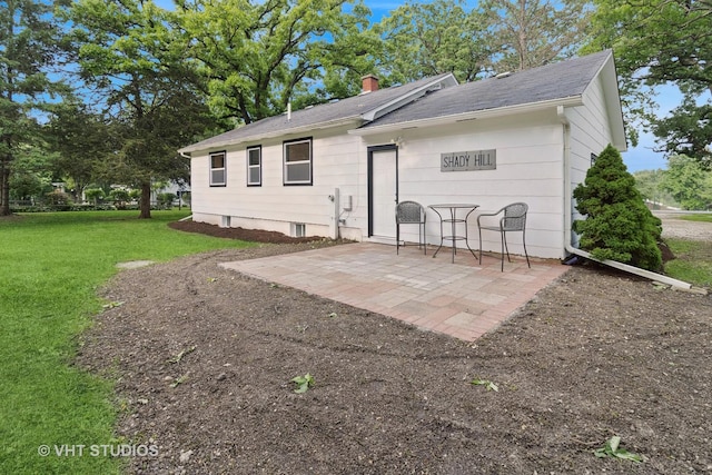2309 N Riverside Dr, Mchenry, IL 60051 - back of property with a lawn, a patio, and a chimney
