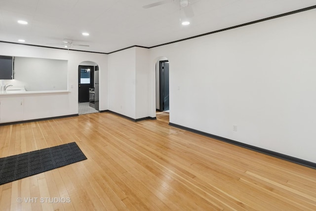 2309 N Riverside Dr, Mchenry, IL 60051 - unfurnished room featuring arched walkways, ceiling fan, a sink, light wood finished floors, and recessed lighting