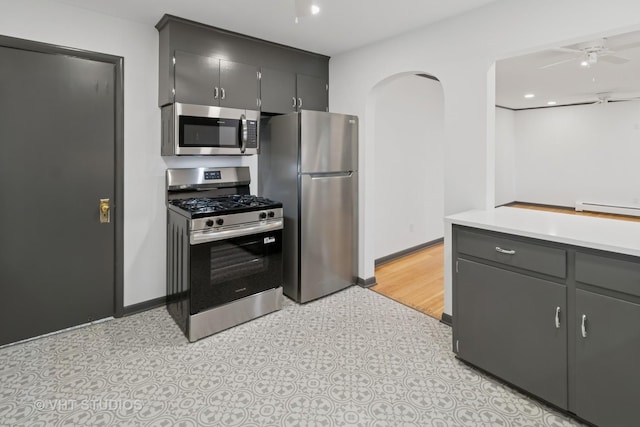2309 N Riverside Dr, Mchenry, IL 60051 - kitchen with appliances with stainless steel finishes, ceiling fan, light countertops, baseboards, and light floors