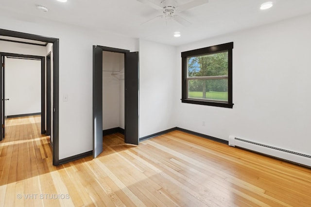 2309 N Riverside Dr, Mchenry, IL 60051 - unfurnished bedroom featuring baseboards, light wood-style floors, recessed lighting, a closet, and baseboard heating