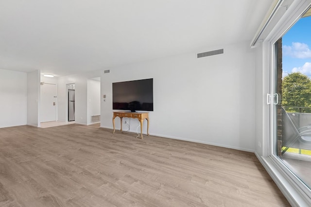 720 Wellington Ave Unit 206, Elk Grove Village, IL 60007 - unfurnished living room featuring light wood-style flooring and baseboards