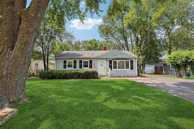 129 S Hammes Ave, Joliet, IL 60436 - ranch-style house with a chimney, a front lawn, entry steps, an outbuilding, and driveway