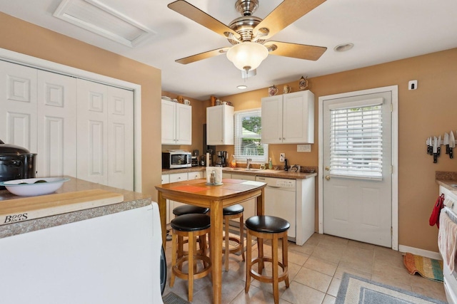 129 S Hammes Ave, Joliet, IL 60436 - kitchen with stainless steel microwave, white dishwasher, refrigerator, and white cabinetry