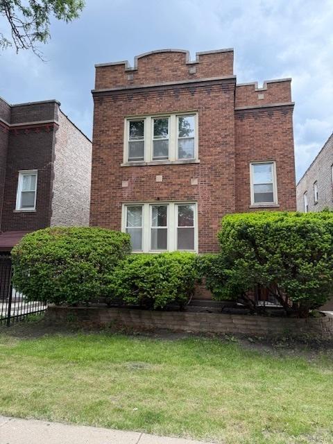 1723 N Monitor Ave, Chicago, IL 60639 - view of front facade with a front lawn and brick siding