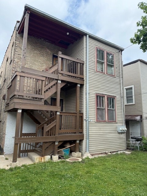 1723 N Monitor Ave, Chicago, IL 60639 - back of property featuring a lawn, brick siding, and a deck