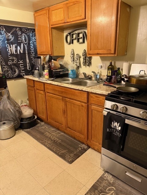 1723 N Monitor Ave, Chicago, IL 60639 - kitchen featuring stainless steel gas range oven, light countertops, and brown cabinets