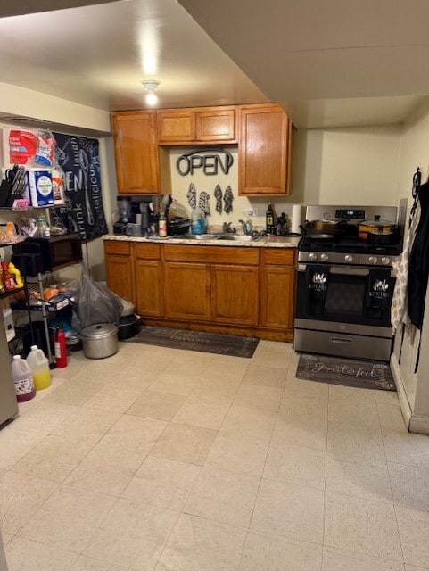 1723 N Monitor Ave, Chicago, IL 60639 - kitchen featuring stainless steel stove, light countertops, and brown cabinetry