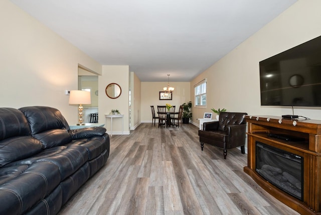 8048 W Magnolia Dr, Frankfort, IL 60423 - living area with a chandelier, wood finished floors, and baseboards