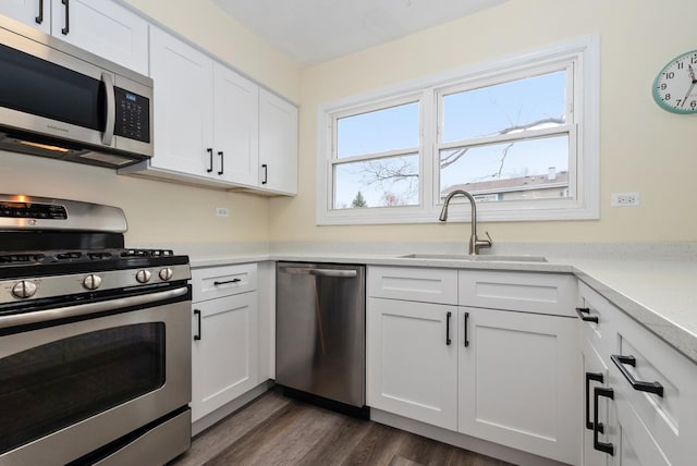 8048 W Magnolia Dr, Frankfort, IL 60423 - kitchen featuring stainless steel appliances, a sink, white cabinets, light countertops, and dark wood finished floors
