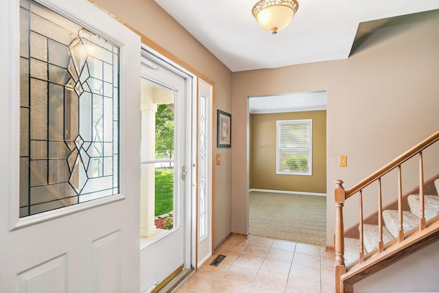 325 Indian Ridge Trl, Wauconda, IL 60084 - entryway with stairway, light colored carpet, baseboards, and light tile patterned floors