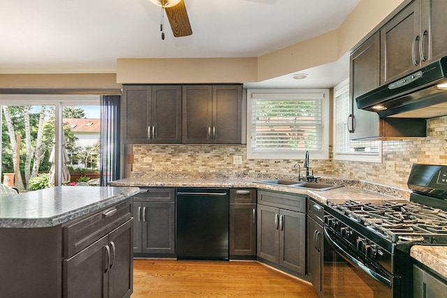 325 Indian Ridge Trl, Wauconda, IL 60084 - kitchen featuring black appliances, a sink, range hood, and healthy amount of natural light