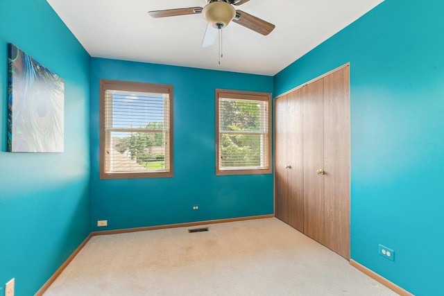325 Indian Ridge Trl, Wauconda, IL 60084 - unfurnished bedroom featuring carpet floors, a closet, baseboards, and a ceiling fan