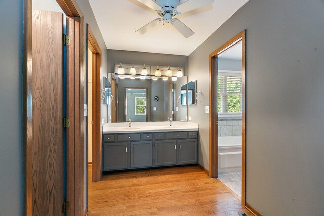 325 Indian Ridge Trl, Wauconda, IL 60084 - bathroom featuring double vanity, wood finished floors, a bath, and a ceiling fan