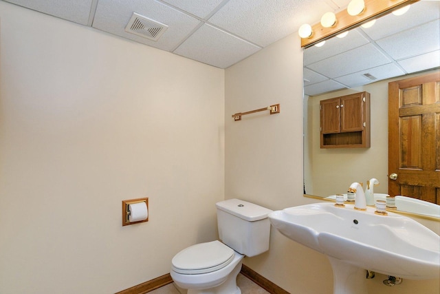 325 Indian Ridge Trl, Wauconda, IL 60084 - half bathroom with a paneled ceiling, toilet, baseboards, and a sink