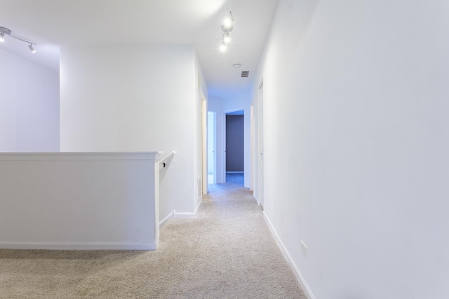 261 Springbrook Trl, Oswego, IL 60543 - corridor with track lighting, an upstairs landing, carpet, and baseboards