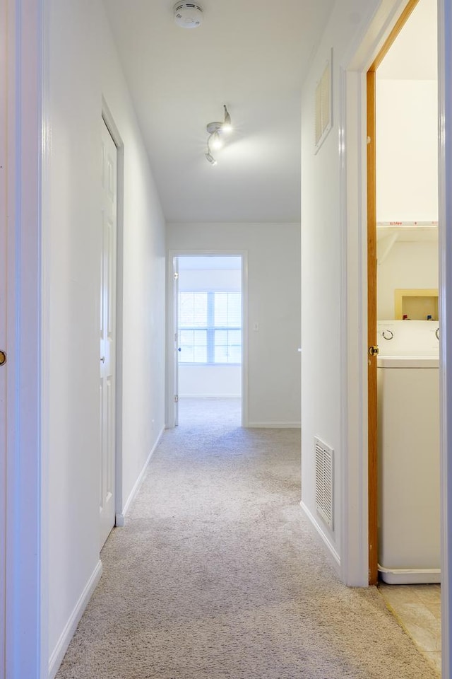 261 Springbrook Trl, Oswego, IL 60543 - corridor featuring washer / clothes dryer, light carpet, and baseboards