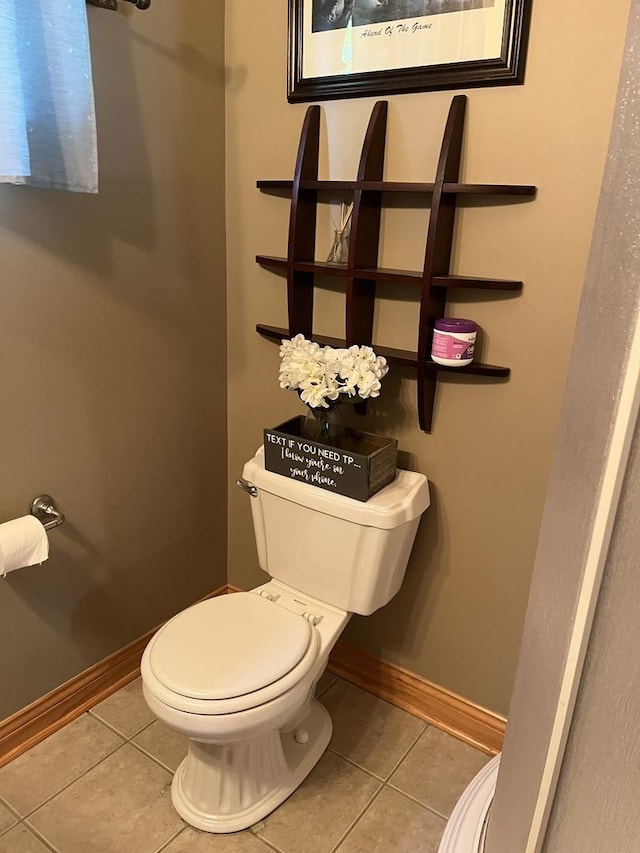 423 Mallard Pt, Danville, IL 61832 - bathroom featuring tile patterned floors, toilet, and baseboards