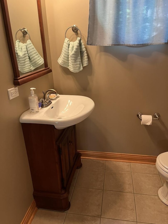 423 Mallard Pt, Danville, IL 61832 - half bath with baseboards, toilet, vanity, and tile patterned flooring