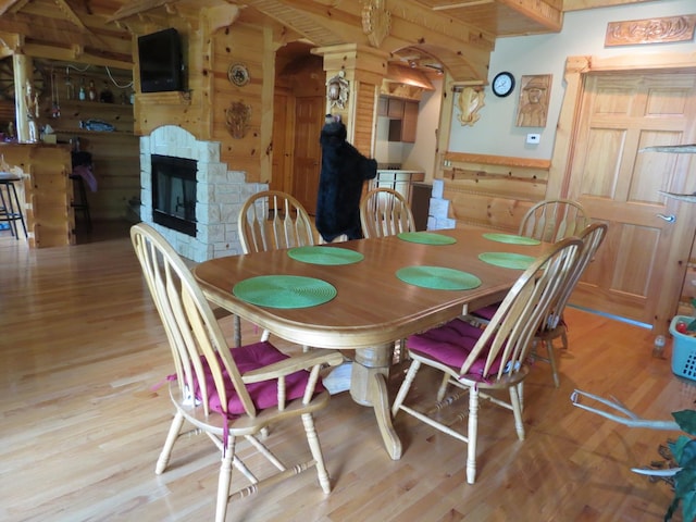 423 Mallard Pt, Danville, IL 61832 - dining area with wood finished floors, wood walls, and a stone fireplace
