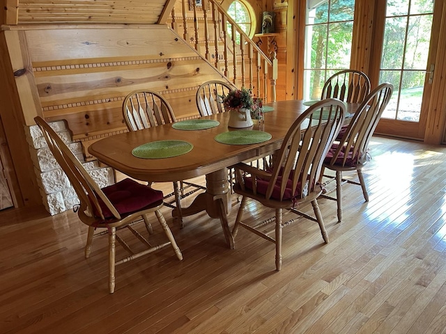 423 Mallard Pt, Danville, IL 61832 - dining area featuring stairs, light wood-style floors, and wood walls