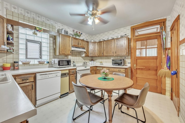 5434 W School St, Chicago, IL 60641 - kitchen with white appliances, light flooring, ceiling fan, wallpapered walls, and under cabinet range hood
