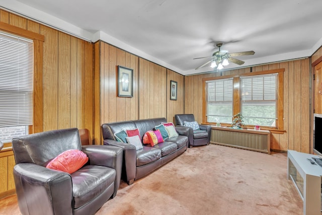 5434 W School St, Chicago, IL 60641 - living area featuring a ceiling fan, wood walls, light colored carpet, and radiator