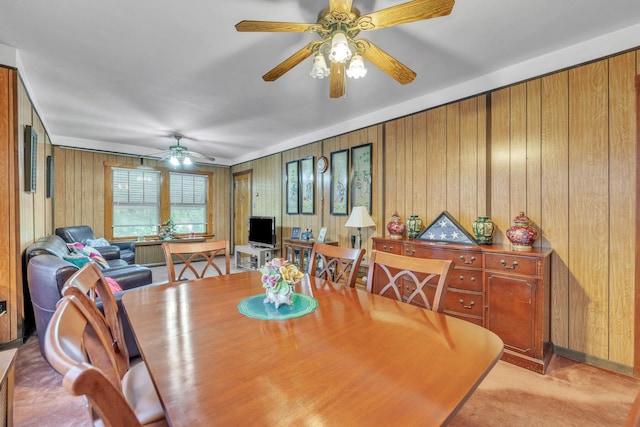 5434 W School St, Chicago, IL 60641 - dining space with a ceiling fan, wooden walls, and light carpet