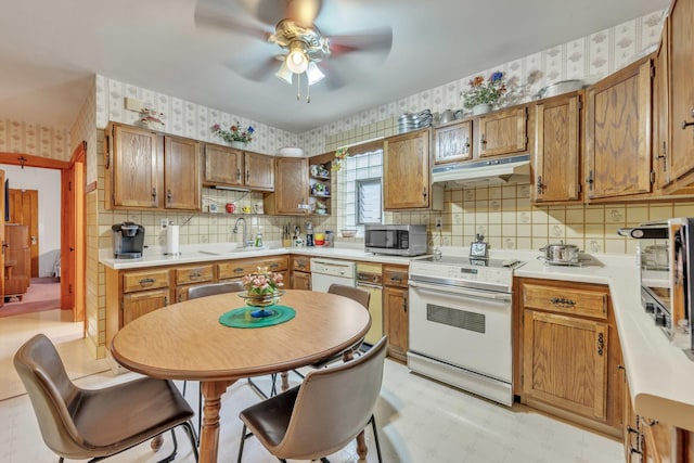 5434 W School St, Chicago, IL 60641 - kitchen with white appliances, a sink, under cabinet range hood, wallpapered walls, and ceiling fan