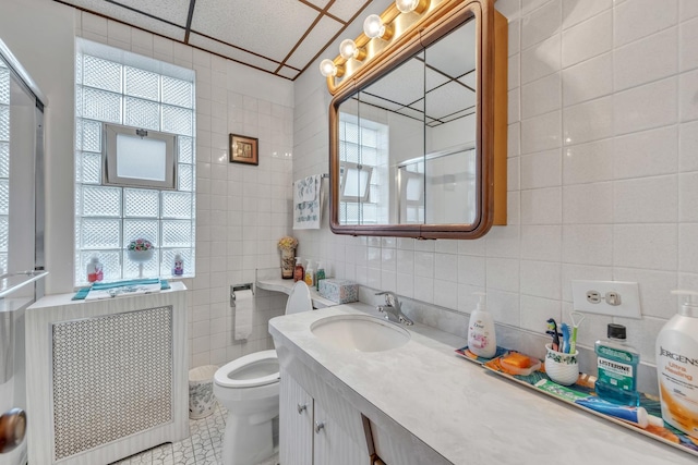 5434 W School St, Chicago, IL 60641 - full bathroom featuring tile walls, vanity, toilet, tile patterned flooring, and a shower with shower door