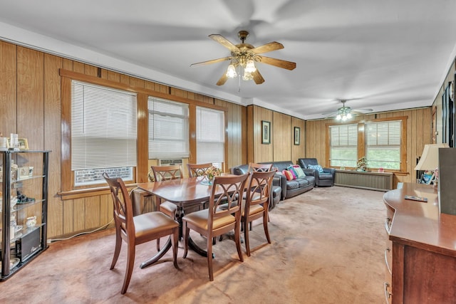 5434 W School St, Chicago, IL 60641 - dining space with wood walls, ceiling fan, and light colored carpet