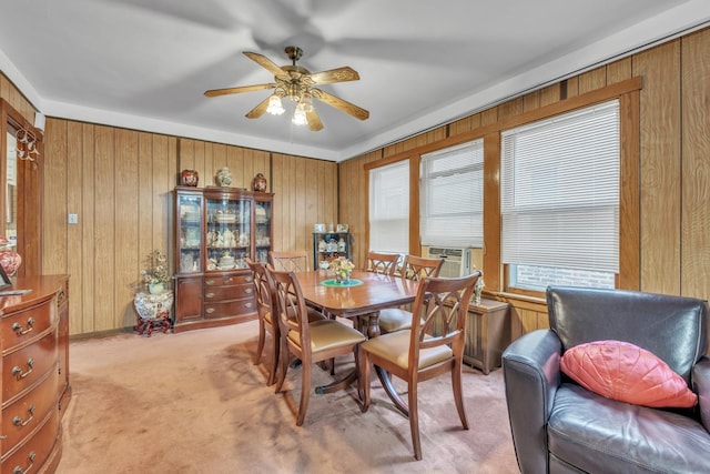 5434 W School St, Chicago, IL 60641 - dining space featuring wooden walls, a ceiling fan, and light carpet