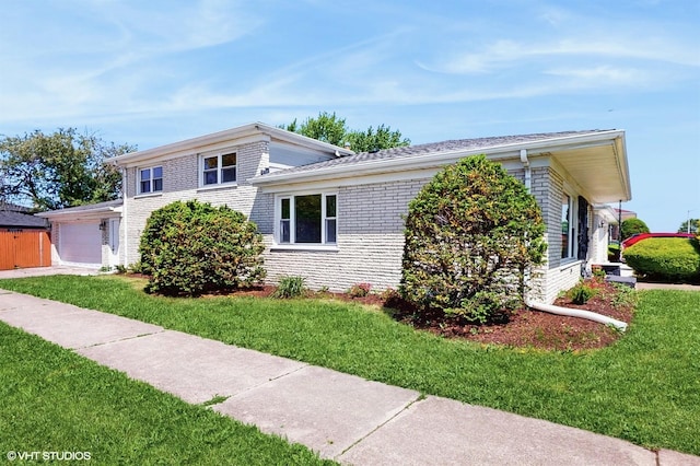 524 Escanaba Ave, Calumet City, IL 60409 - view of front of house featuring a front yard, brick siding, and a garage