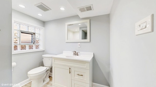 524 Escanaba Ave, Calumet City, IL 60409 - bathroom featuring baseboards, toilet, vanity, wood finished floors, and recessed lighting
