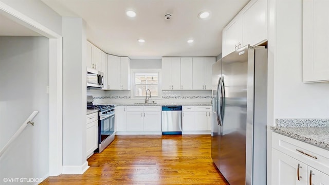 524 Escanaba Ave, Calumet City, IL 60409 - kitchen featuring appliances with stainless steel finishes, a sink, white cabinetry, and recessed lighting