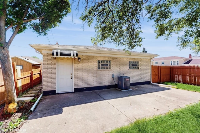 524 Escanaba Ave, Calumet City, IL 60409 - rear view of property with cooling unit, a patio, brick siding, and a fenced backyard