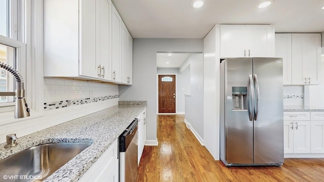 524 Escanaba Ave, Calumet City, IL 60409 - kitchen with stainless steel appliances, a sink, white cabinetry, light wood finished floors, and recessed lighting