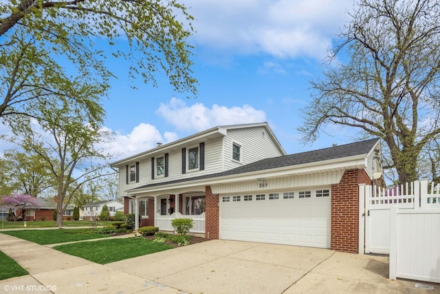 265 W Adams St, Elmhurst, IL 60126 - traditional-style house with brick siding, an attached garage, and driveway
