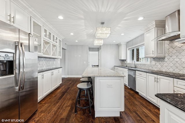 265 W Adams St, Elmhurst, IL 60126 - kitchen featuring appliances with stainless steel finishes, wall chimney range hood, recessed lighting, decorative backsplash, and white cabinetry