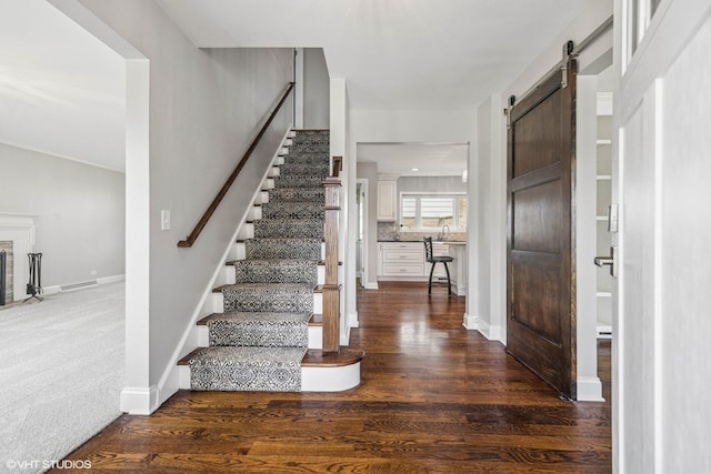 265 W Adams St, Elmhurst, IL 60126 - foyer with a barn door, stairs, wood finished floors, and baseboards