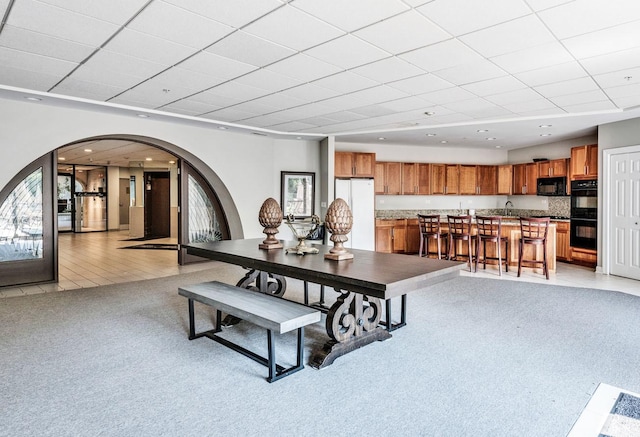1 Renaissance Pl Unit 805, Palatine, IL 60067 - dining area featuring light colored carpet, arched walkways, and a drop ceiling