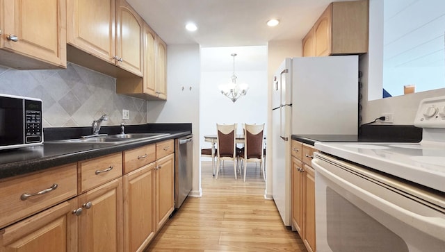 1 Renaissance Pl Unit 805, Palatine, IL 60067 - kitchen featuring appliances with stainless steel finishes, a sink, a chandelier, light wood finished floors, and tasteful backsplash