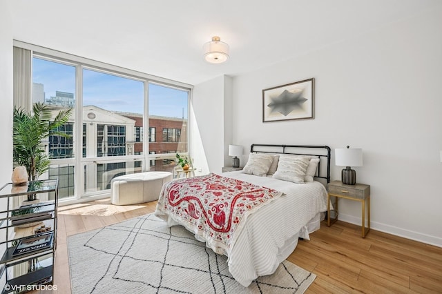 757 N Orleans St Unit 711, Chicago, IL 60654 - bedroom with wood finished floors, expansive windows, and baseboards
